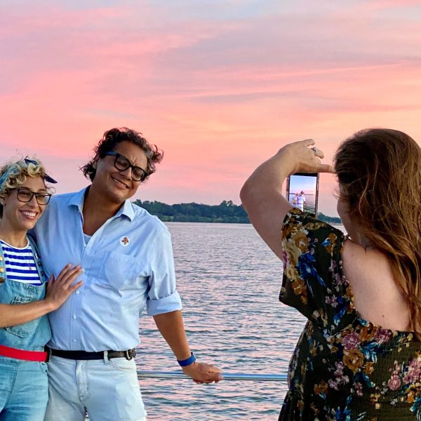 a man and a woman standing in front of water