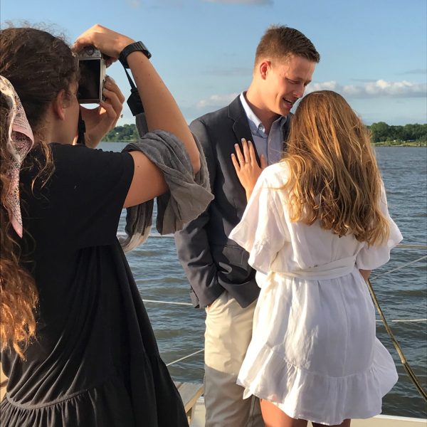 a man and a woman standing in front of water