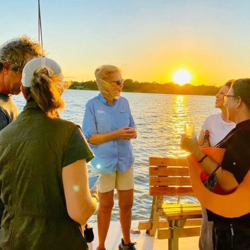 a group of people are drinking from the water